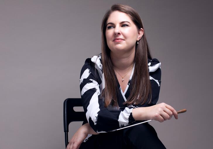Karen Ni Bhroin sitting down holding her baton