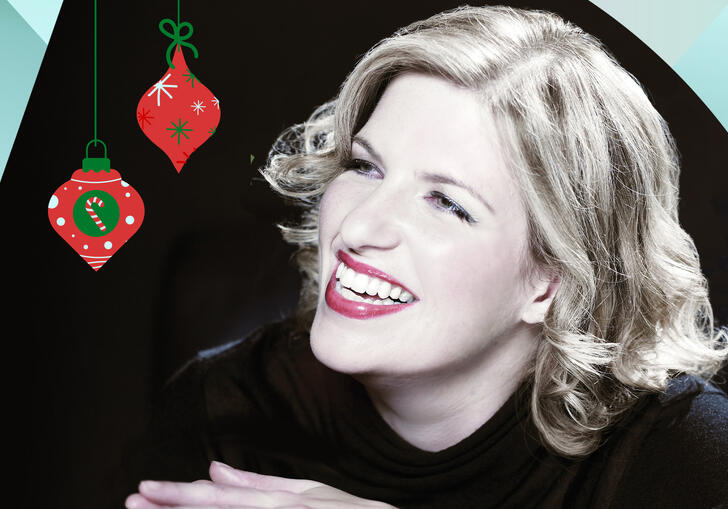 Clare Teal smiling, with turquoise and orange shapes bordering the image and two Christmas baubles hanging from the top of the image