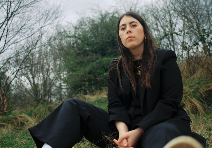 Sorcha Richardson sits in the middle of a woodland clearing