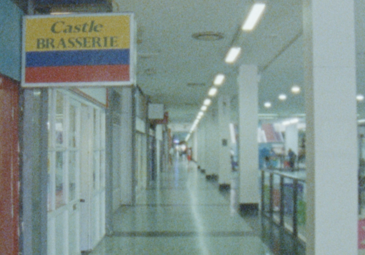 A hospital corridor in fluorescent lights.