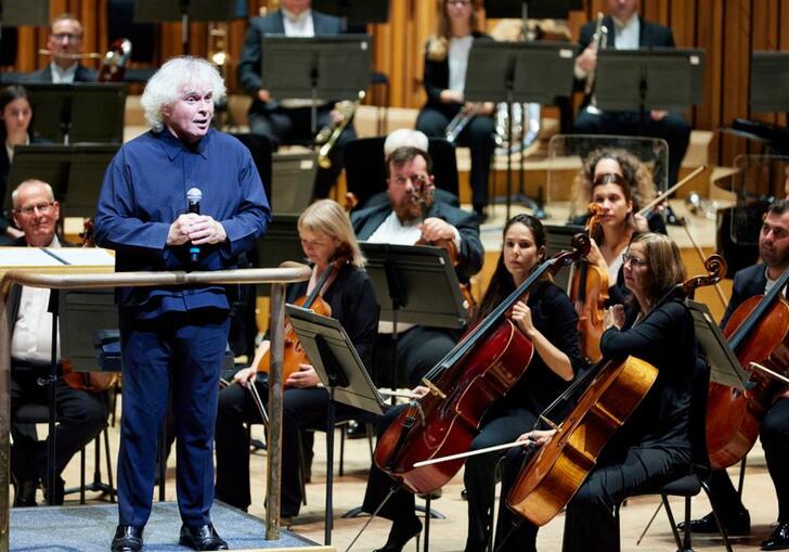 Sir Simon Rattle presenting from the Barbican stage