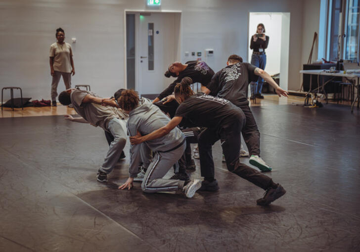 Members of the Boy Blue company rehearse, the group together as if moving in a spiralling motion.