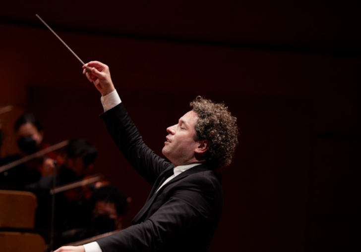 A side-on shot of Gustavo Dudamel conducting