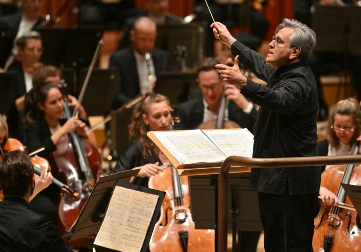 Sir Antonio Pappano conducting the LSO on the Barbican stage, with LSO cellos and violas in the background.