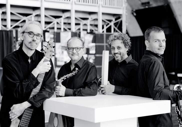 Anouar Brahem Quartet stand with their instruments, smiling to camera