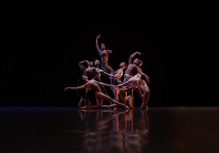 Members of the Ballet Black ensemble pose together, they move fluidly between and around one another.