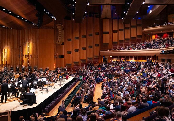 The London Symphony Orchestra on the Barbican Hall stage in front of a full audience of families