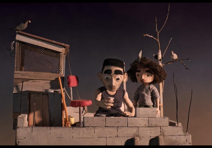 An animation of a man and a woman in front of a sunset, the man lays bricks on a wall whilst the woman watches on.