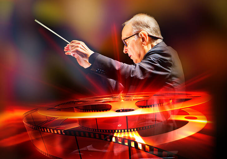 Ennio Morricone conducting, with an image of a reel of film in glowing red colours overlaid
