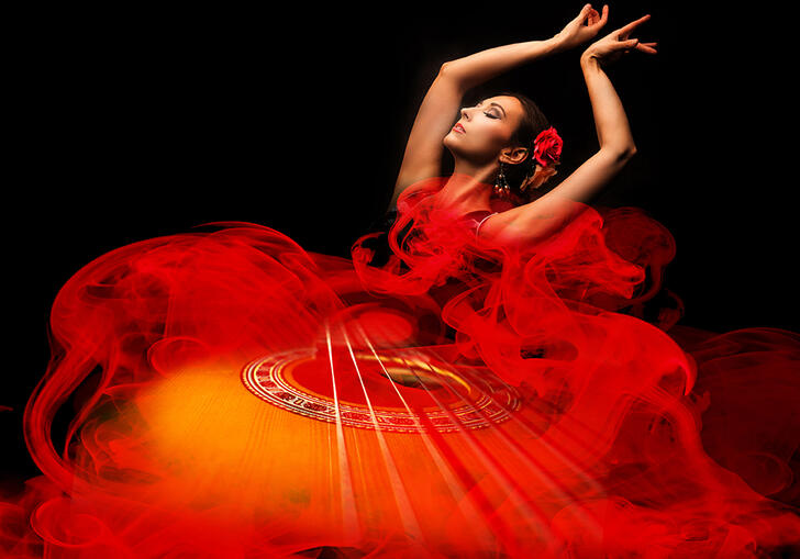 A Spanish flamenco dancer dancing in a red dress. An image of a guitar is Photoshopped on top of her dress.
