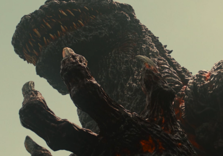 A monster appears in a dark skyline.