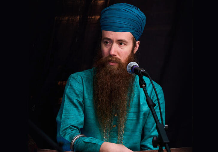 Kirit Singh singing into a microphone