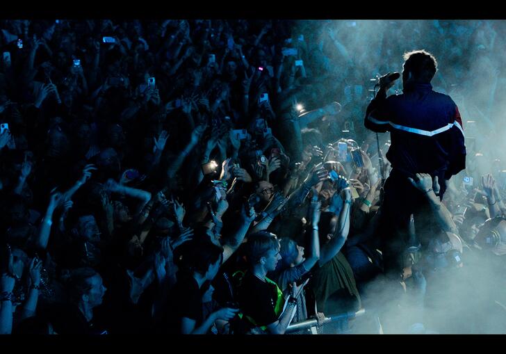 Blur perform live on stage close to the crowd 