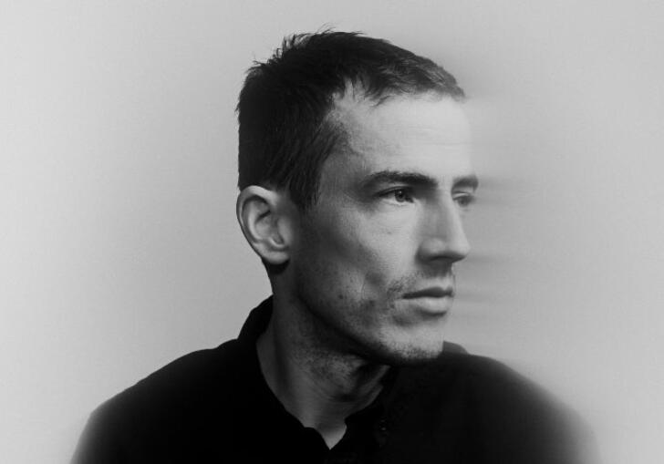 Charlie Cunningham in blurred, black and white image looking to the right pensively