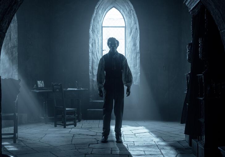 Nicholas Hoult stands in room