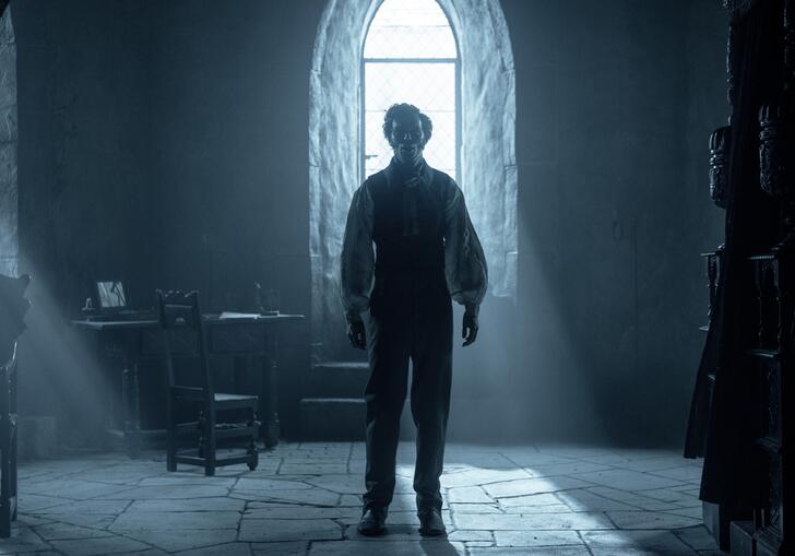 Nicholas Hoult stands in room