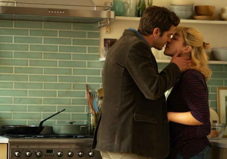 Andrew Garfield cups Florence Pugh's face, as they are about to kiss