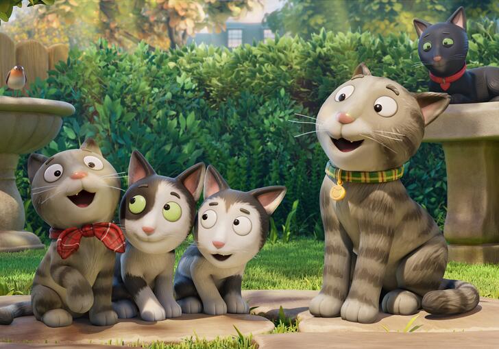 A cat and kittens are in a garden.