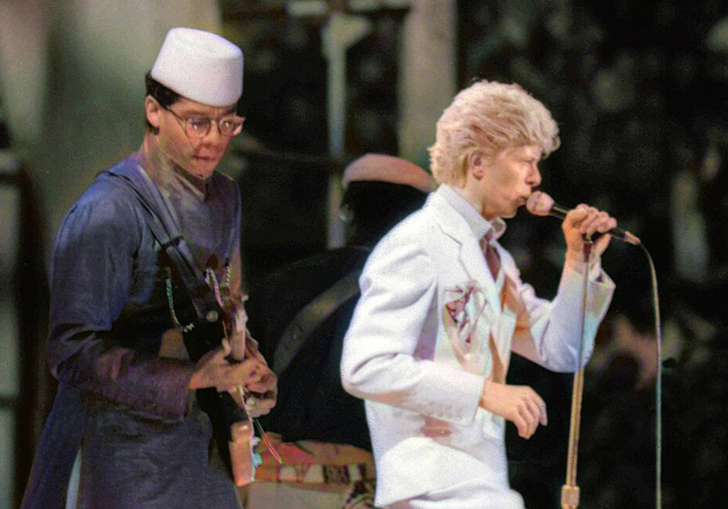 Guitarist Carlos Alomar on stage next to David Bowie