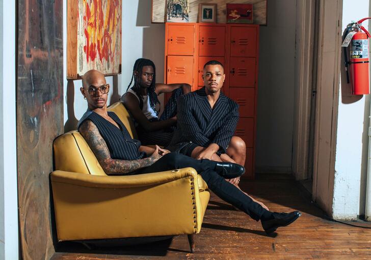 Three people sitting on a sofa 