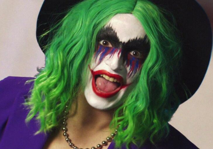 Vera Drew dressed as the Joker looks into the camera,