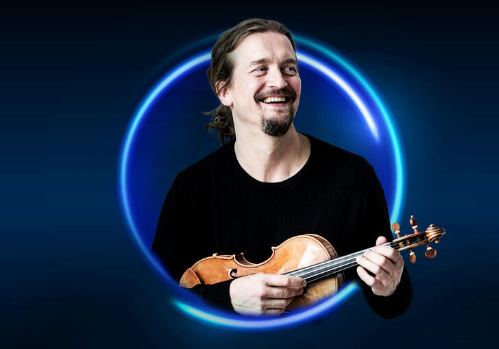 n image of Christian Tetzaff surrounded by a blue circle against a blue background