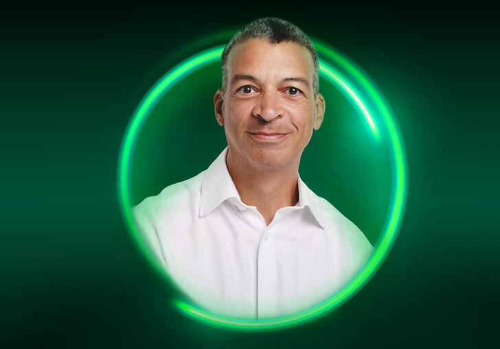 An image of Roderick Williams surrounded by a green circle against a green background
