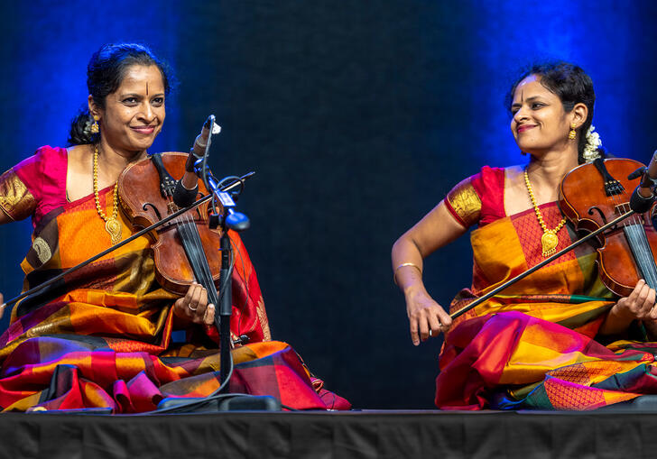Akkarai sisters playing the violin on stage