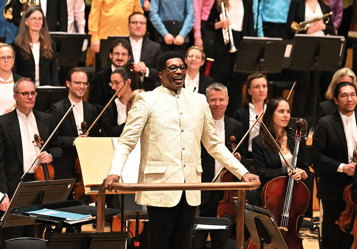 Andre J Thomas facing the audience in the Barbican concert hall