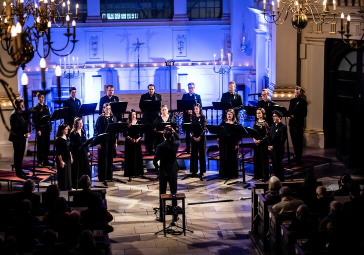 A choir singing on stage in a church