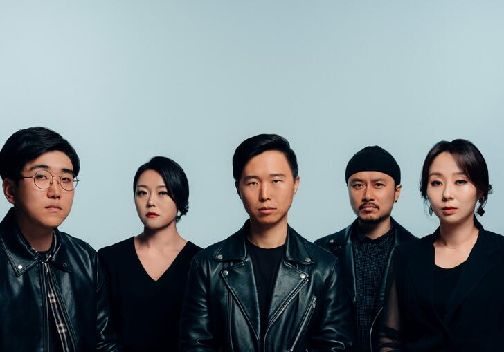 Image of all members of Jambinai against alight blue backdrop