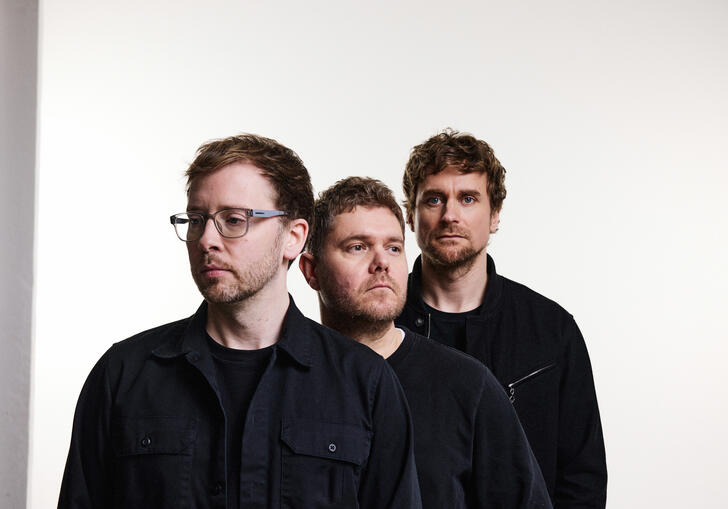 Image of the Manchester trio GoGo Penguin standing next to each other against a white backdrop.