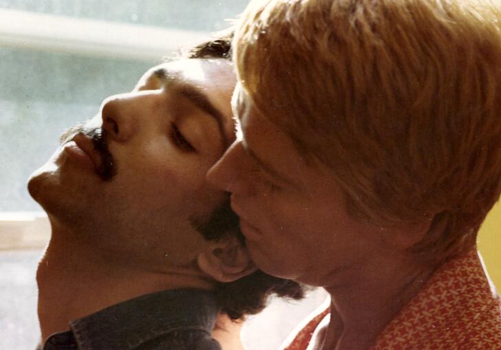A still from Adam & Yves, showing two men in a close embrace