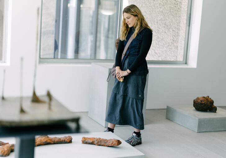 A young woman looking at artwork in a gallery