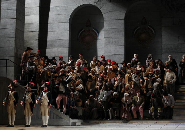 A scene froom Andrea Chenier, showing a group of French revolutionaries on the steps of a grand building