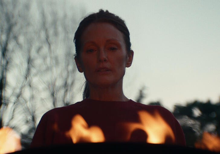 Julianne Moore looks down into a row of flames