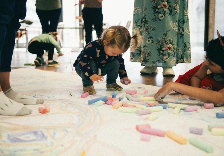 Young children drawing with chalk