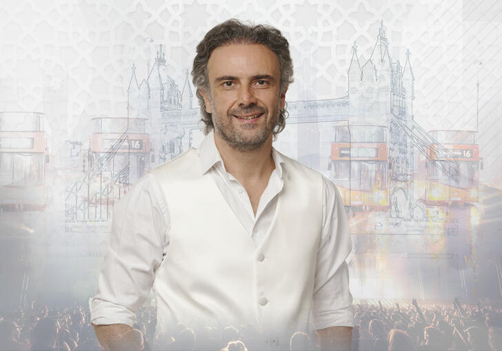 photo of Iyad Rimawi in a white shirt in front of a grey and white background