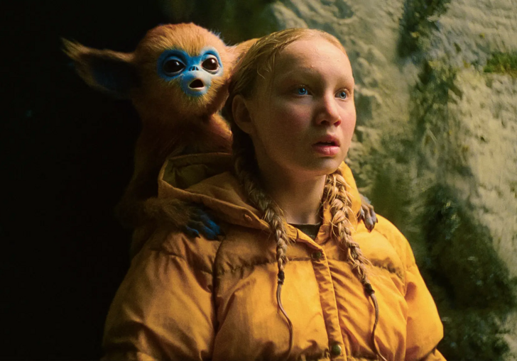 A girl with a monkey-like creature