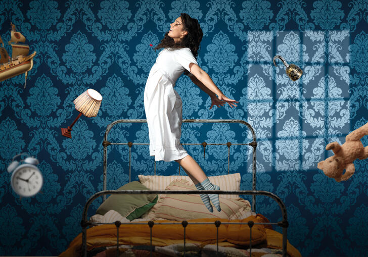 A person starts to fly in the air, levitating above their bed