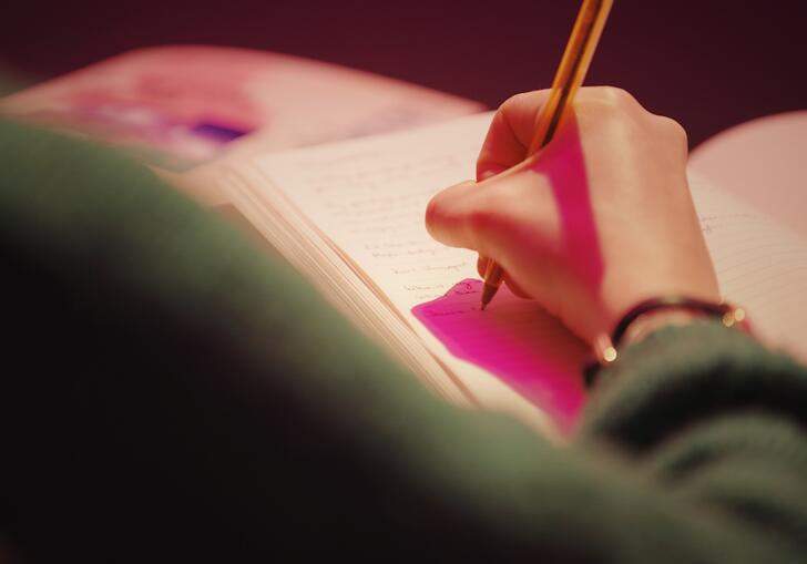 A person writing in a book