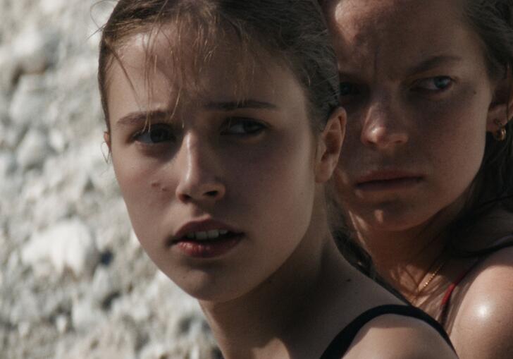 Two young girls looking into the distance.