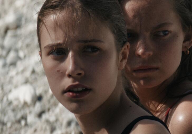 Two young girls looking into the distance.