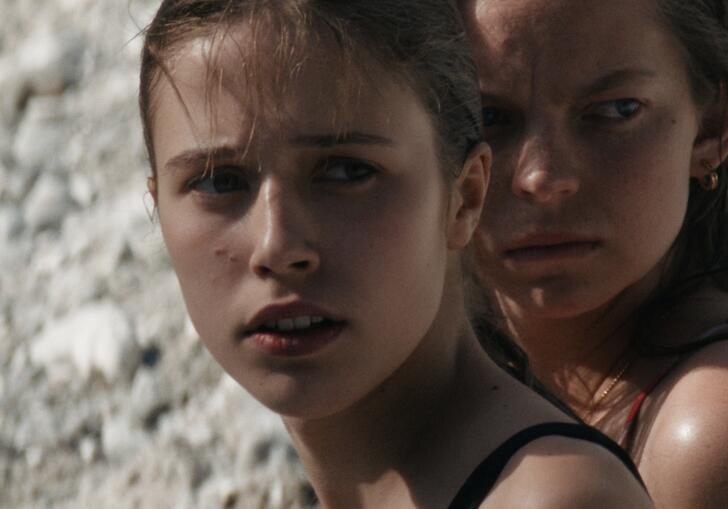 Two young girls looking into the distance.