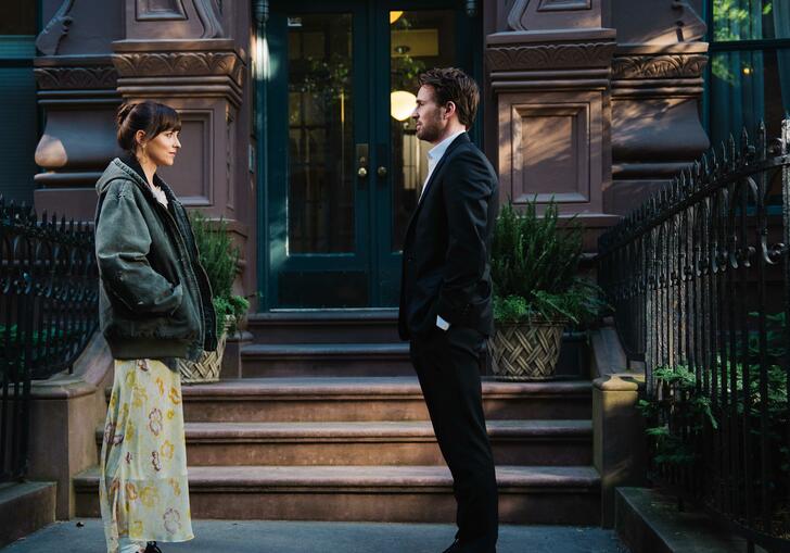 A man and a woman facing each other on the street.