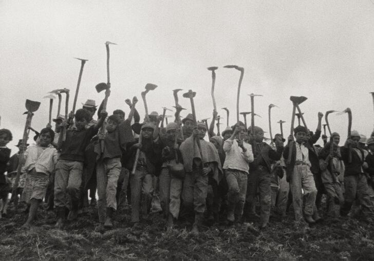 People standing with their tools in hand.