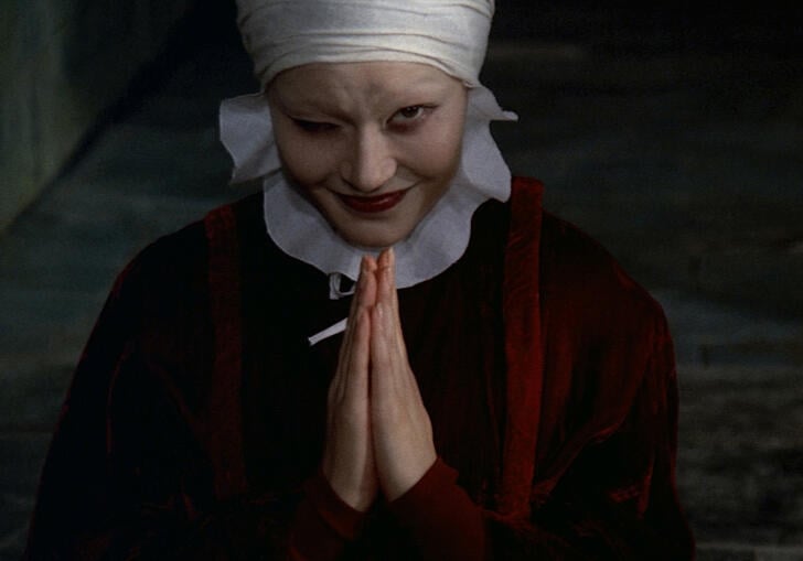 a women winking with her hands together