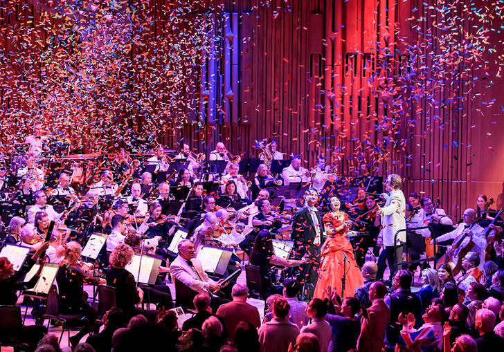 Confetti falling over an orchestra on stage