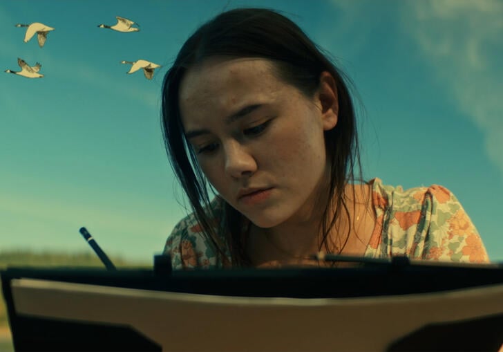 A young woman writing