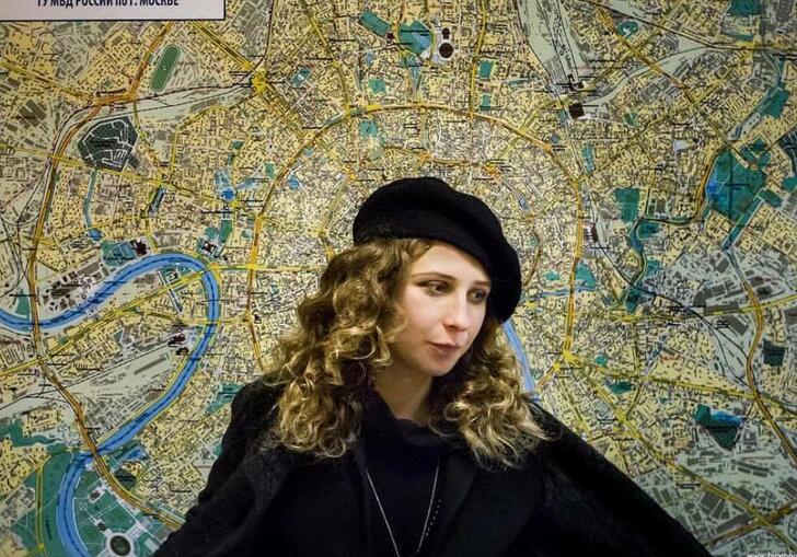 Portrait of Maria Alyokhina against a background of a map